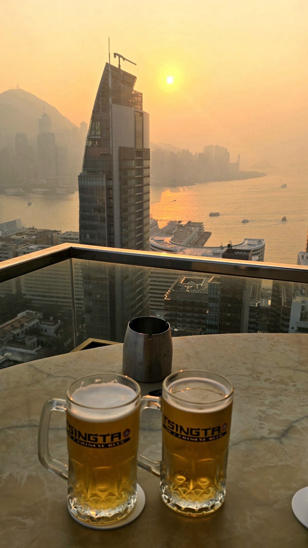Two Tsingtao beers at the Eye Bar, sunset over the harbour