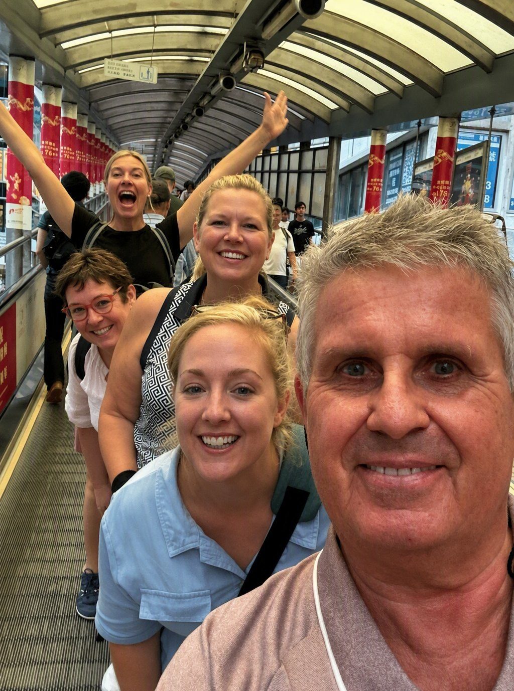 Hans and guests laughing on the Mid-Levels escalator